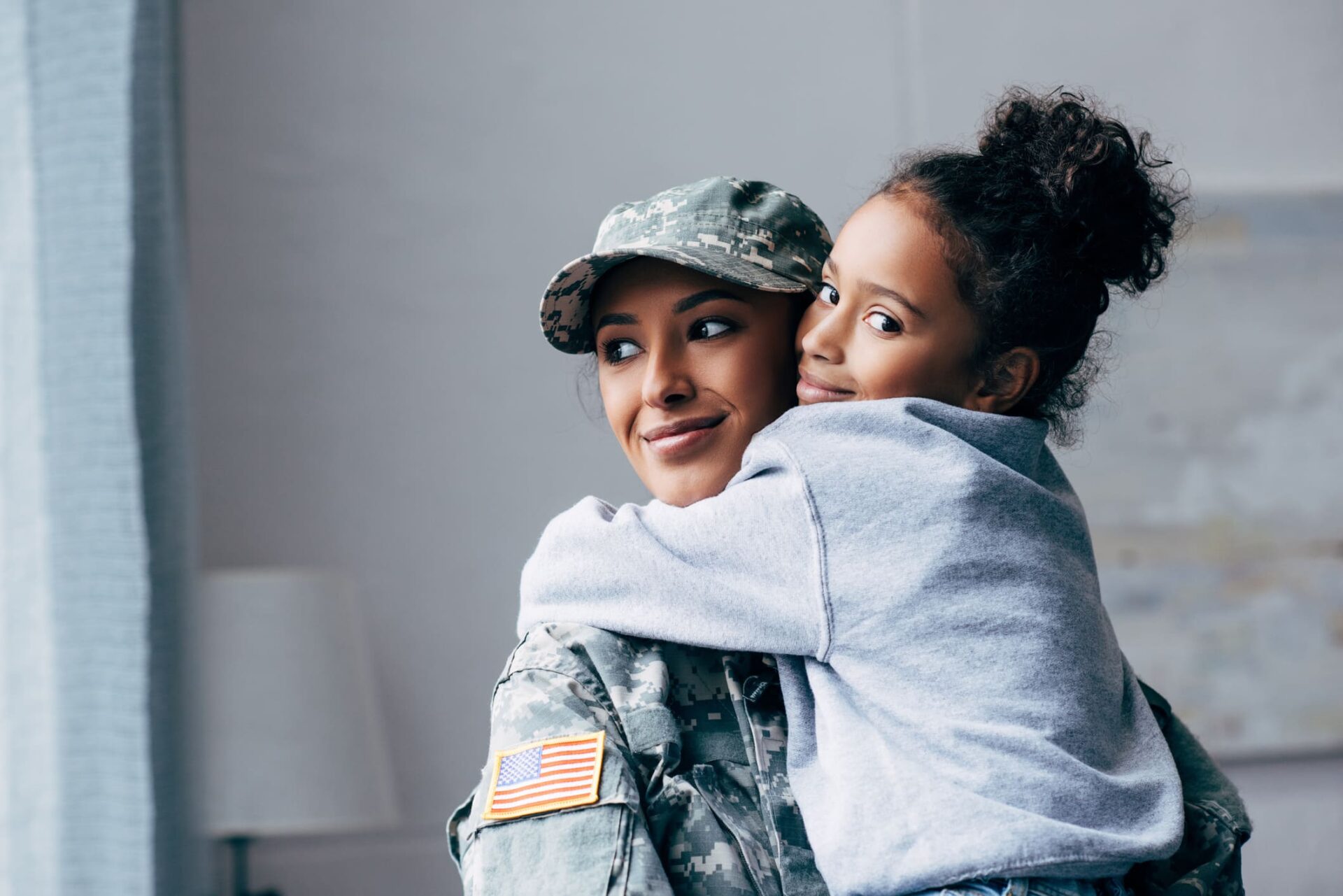 Military woman holding her daughter