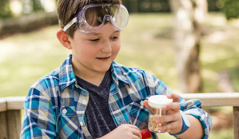 Boy using goggle while doing experiments