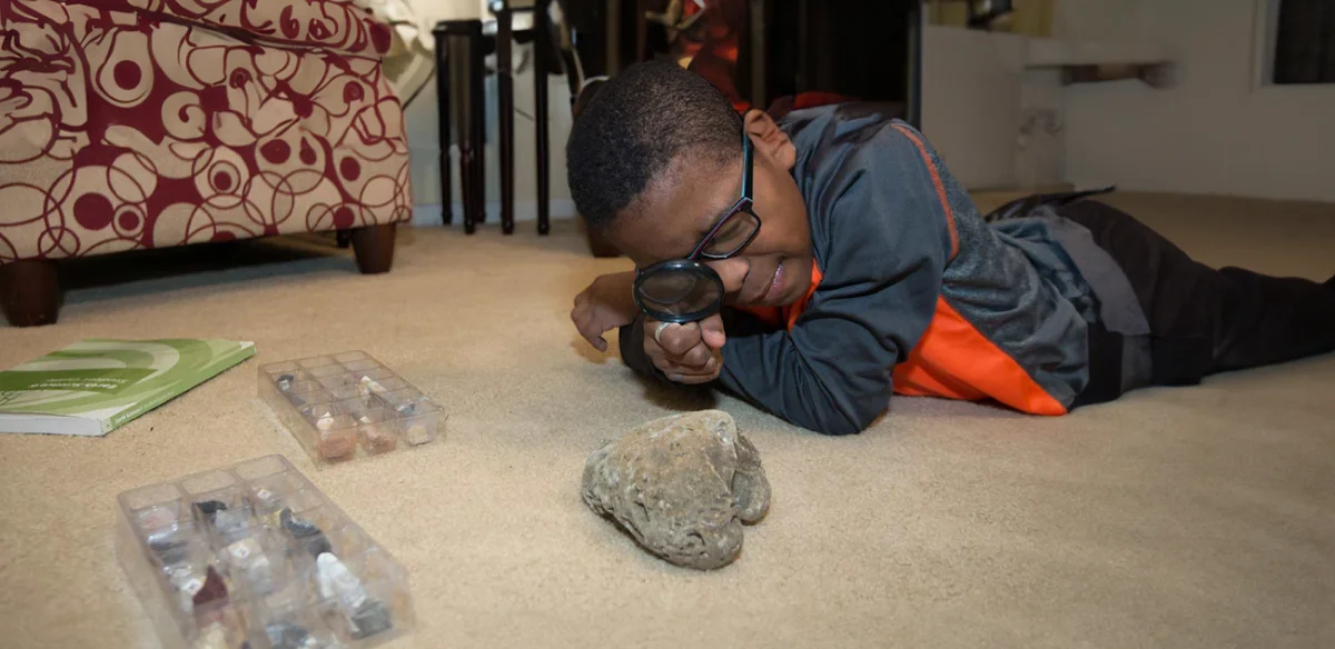 Student looking at rocks